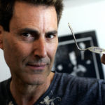 Israeli magician Uri Geller holds a spoo