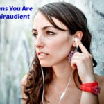 beautiful woman listening to music with phone player in the city