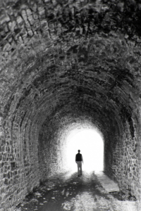 Man walking through tunnel during a Near Death Experience 